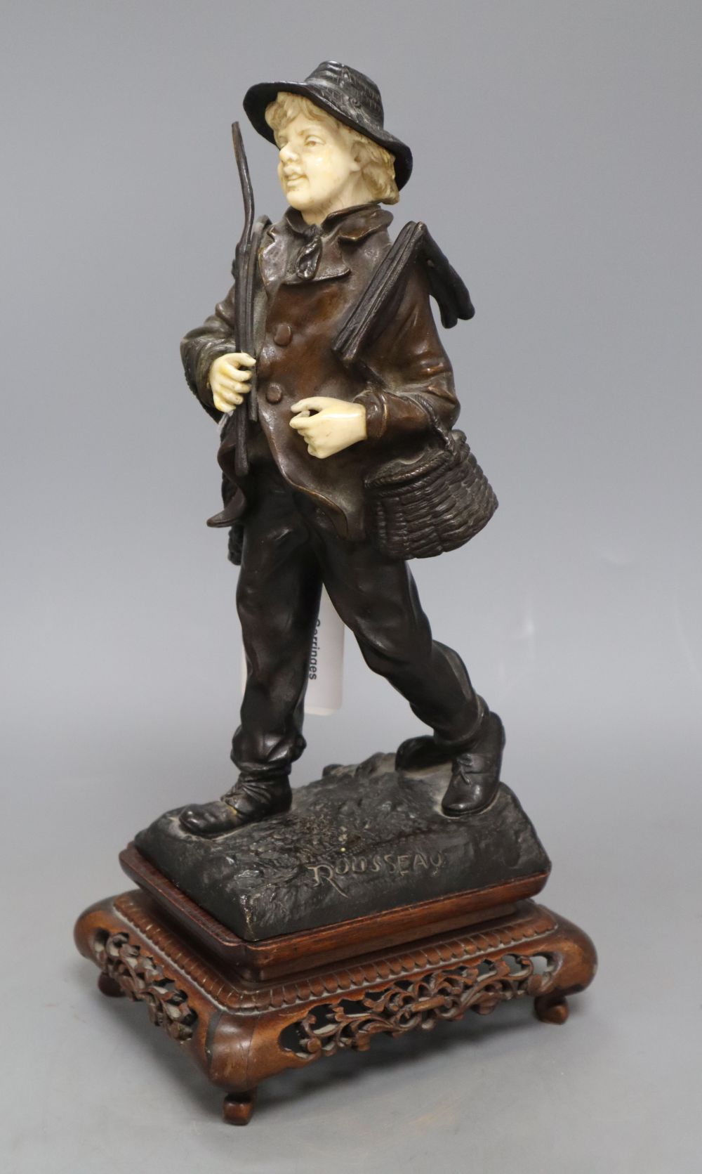 Rousseau. A bronze and ivory figure of a fisherboy, signed, height 26cm
